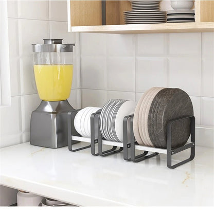 Three kitchen dish storage racks on the kitchen counter holding different sizes of dinner plates, salad plates, and cereal bowls.