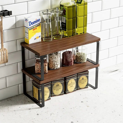 Wooden kitchen racks with kitchen items including oil bottles, a box of Domino sugar, and various containers on a tiled wall background.