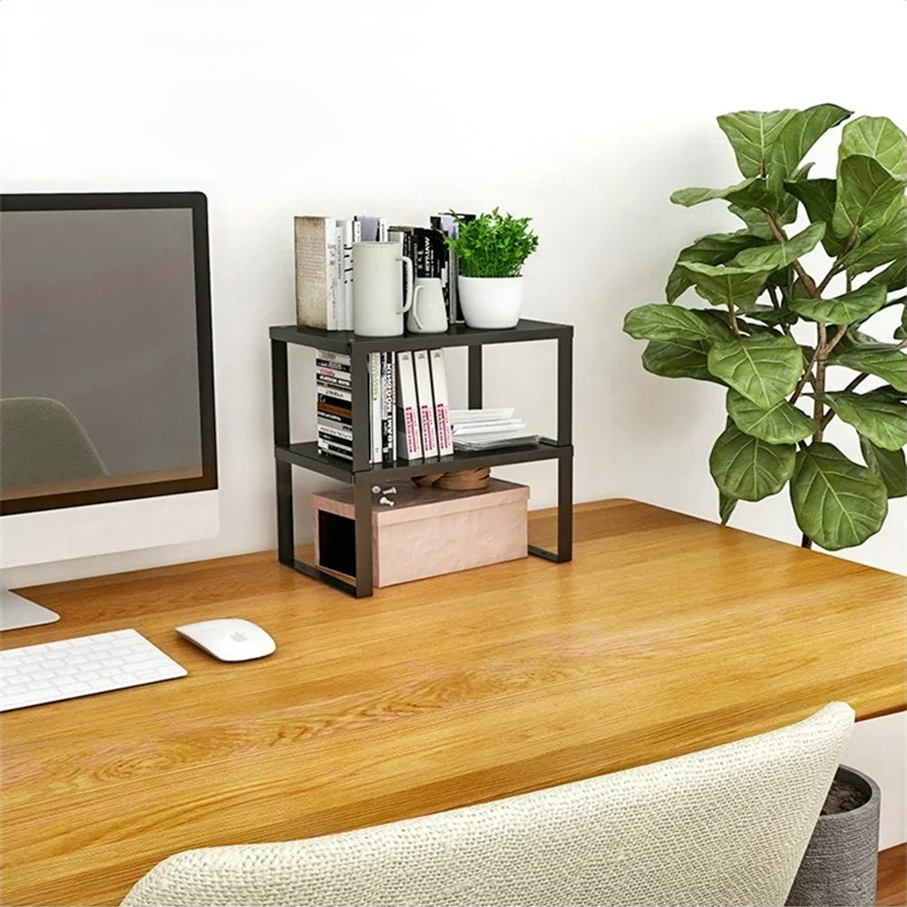 Two kitchen shelf racks are placed on a work desk that holds books, mugs, a plant pot, and papers for neat and stylish organization.