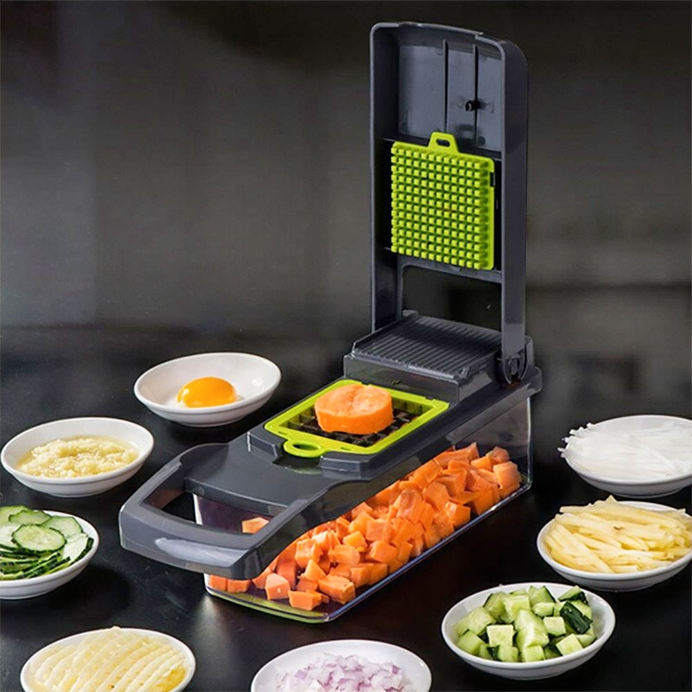 KitchenAid cheese grater slicing carrots with various vegetables arranged around it.