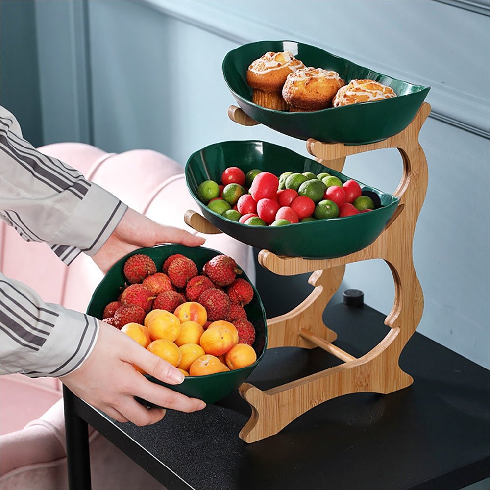 A large fruit bowl in green, overflowing with a variety of fresh fruits, perfect for stylish and ample display.