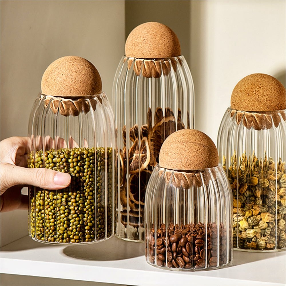 Large glass jars with cork lids, ideal for stylish kitchen storage of pantry essentials.