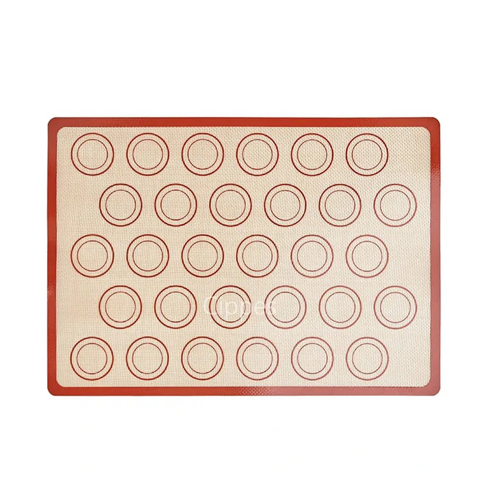Silicone baking mat with circular shapes on a white background.