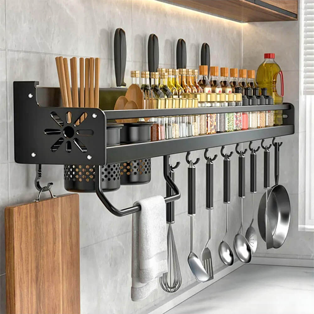 Magnetic kitchen storage rack with hooks and containers holding utensils, spices, knives, and cooking tools in a tidy layout.
