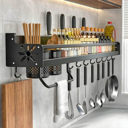 Magnetic kitchen storage rack with hooks and containers holding utensils, spices, knives, and cooking tools in a tidy layout.