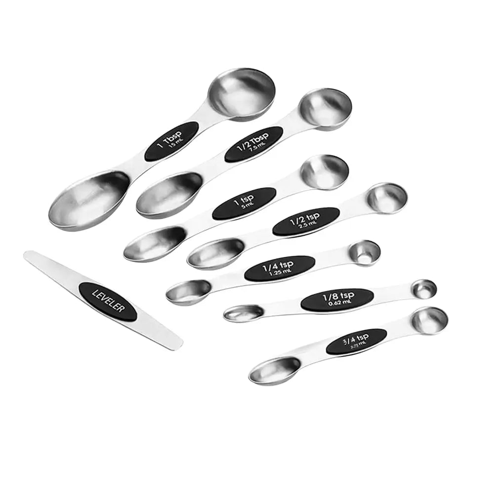 Set of stainless steel magnetic measuring spoons with labeled measurements on a white background.