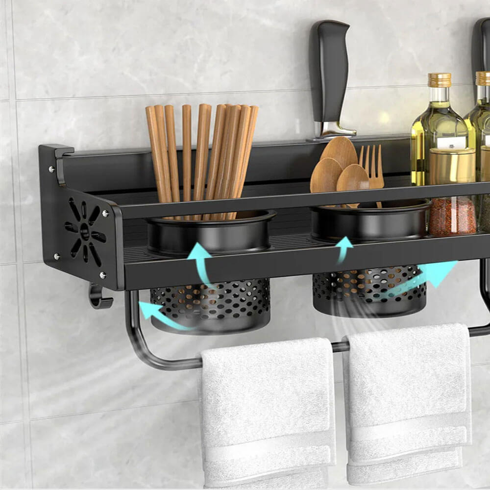 Magnetic spice storage rack mounted on wall holds utensils, jars, and towels with drainage containers and drying feature.