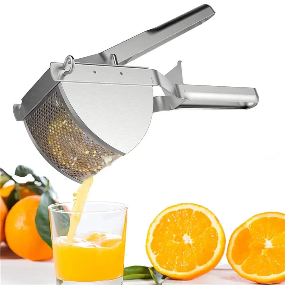 Stainless steel mash potato masher, squeezing fresh orange juice into a glass with oranges on the table.