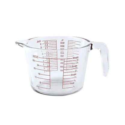 Clear measuring cup glass with red markings for cups, ounces, and milliliters. Perfect for accurate liquid and dry ingredient measuring.