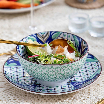 A cereal bowl full of food on a dining table is part of a modern dinnerware set with a sleek and contemporary design.