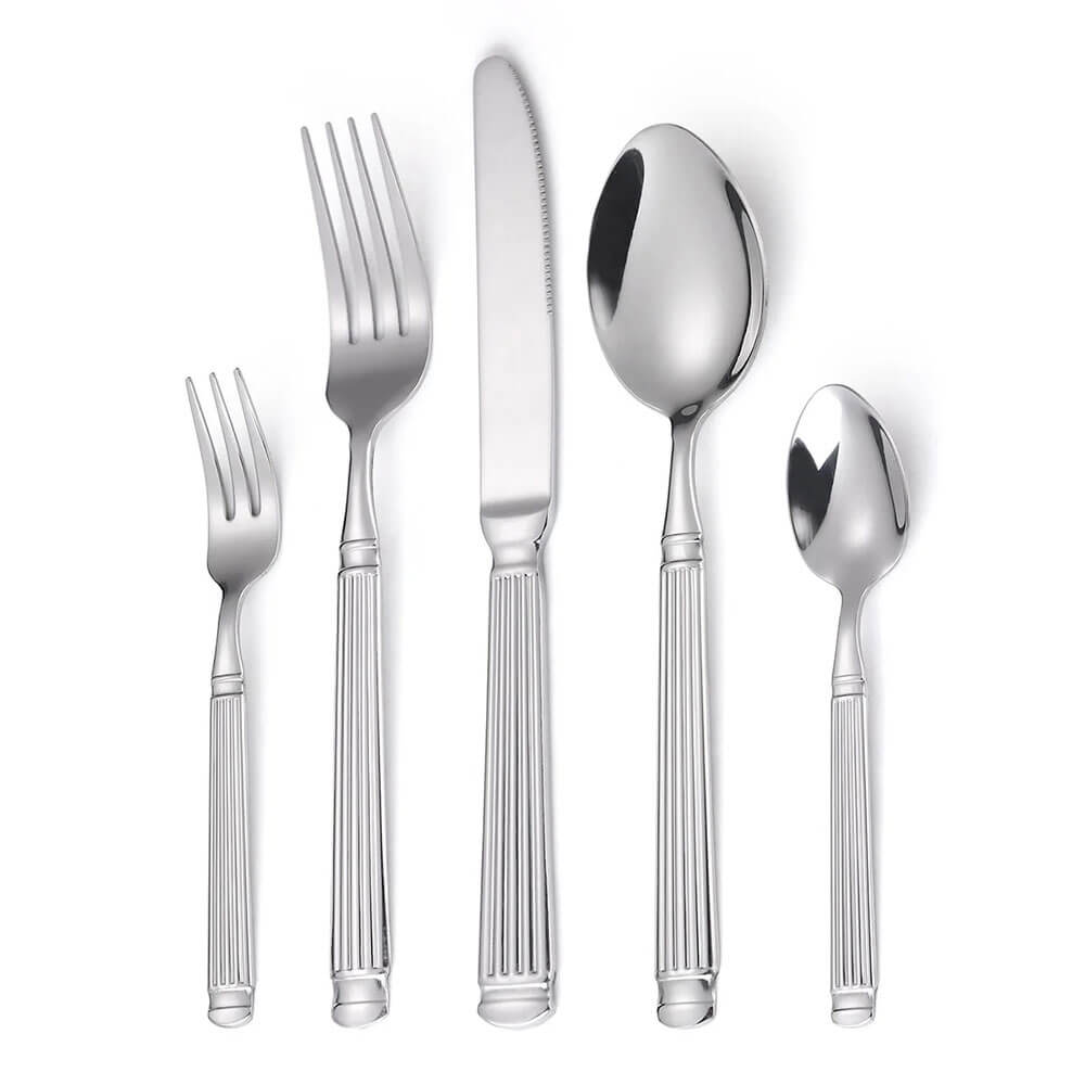 Modern flatware set with ribbed stainless steel handles, includes two forks, two spoons, and a knife neatly arranged.