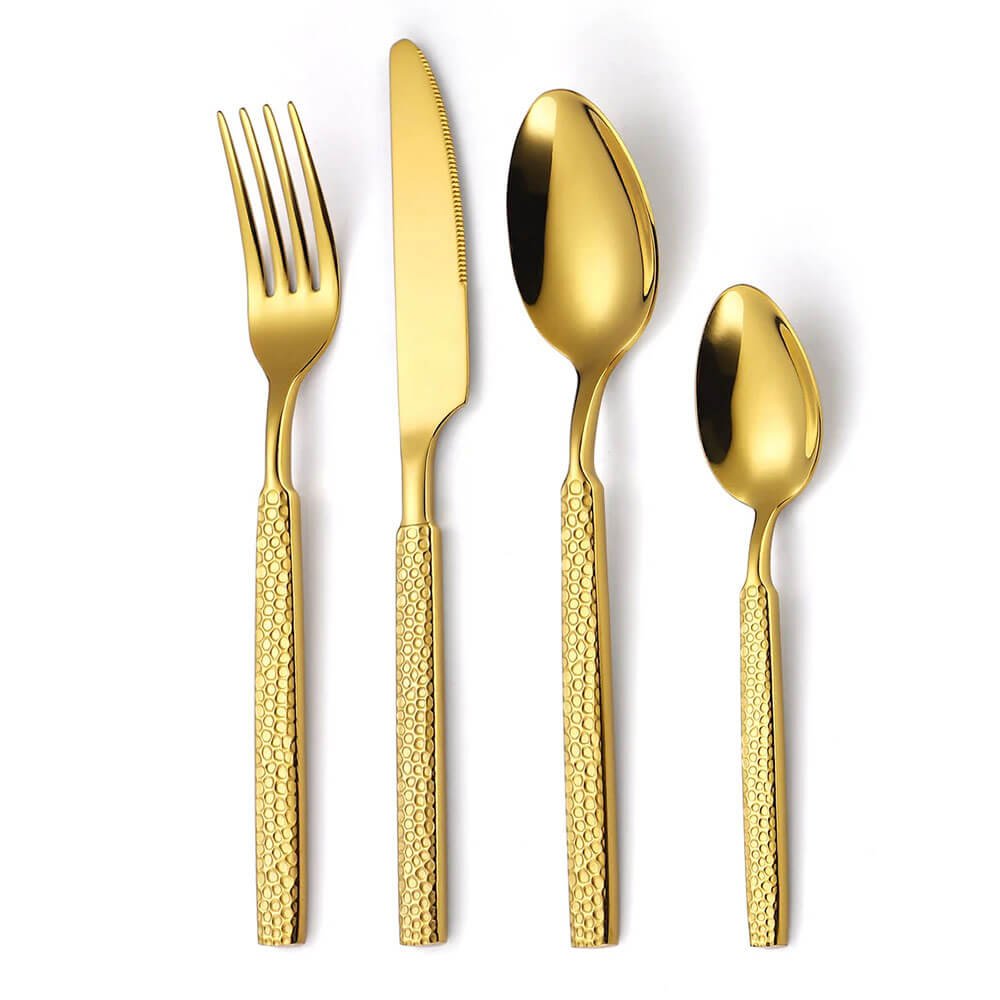 A close-up view of a modern flatware set featuring a fork, knife, tablespoon, and teaspoon. Each piece is crafted with a polished gold finish, showcasing a sleek and reflective surface. The handles are textured with a refined, honeycomb-like pattern, adding a contemporary and elegant touch to the design. The set is displayed against a plain white background, highlighting the vibrant gold tone and sophisticated craftsmanship.