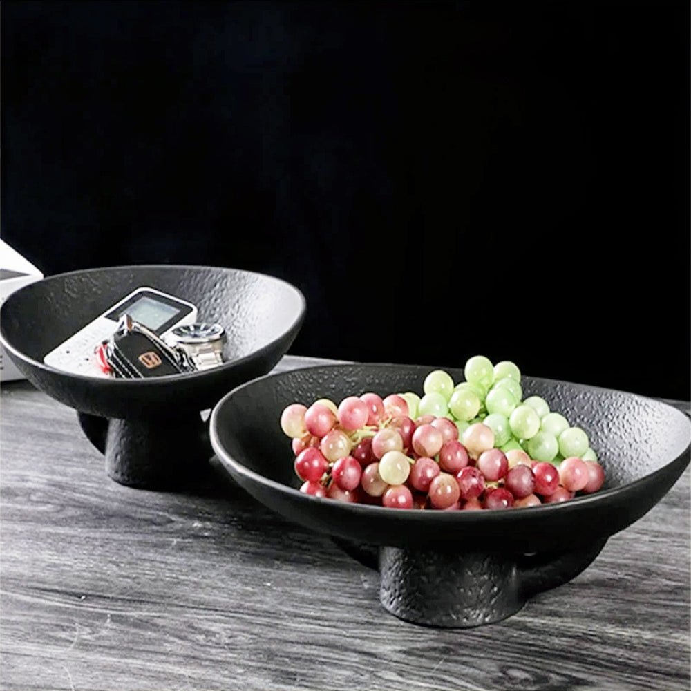 Sleek black modern fruit bowl, perfect for stylishly organizing fruit on your kitchen counter.