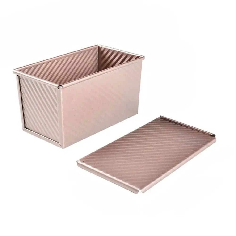 Non-stick loaf pan with diagonal ridges and a matching removable lid, shown in a metallic finish on a white background.
