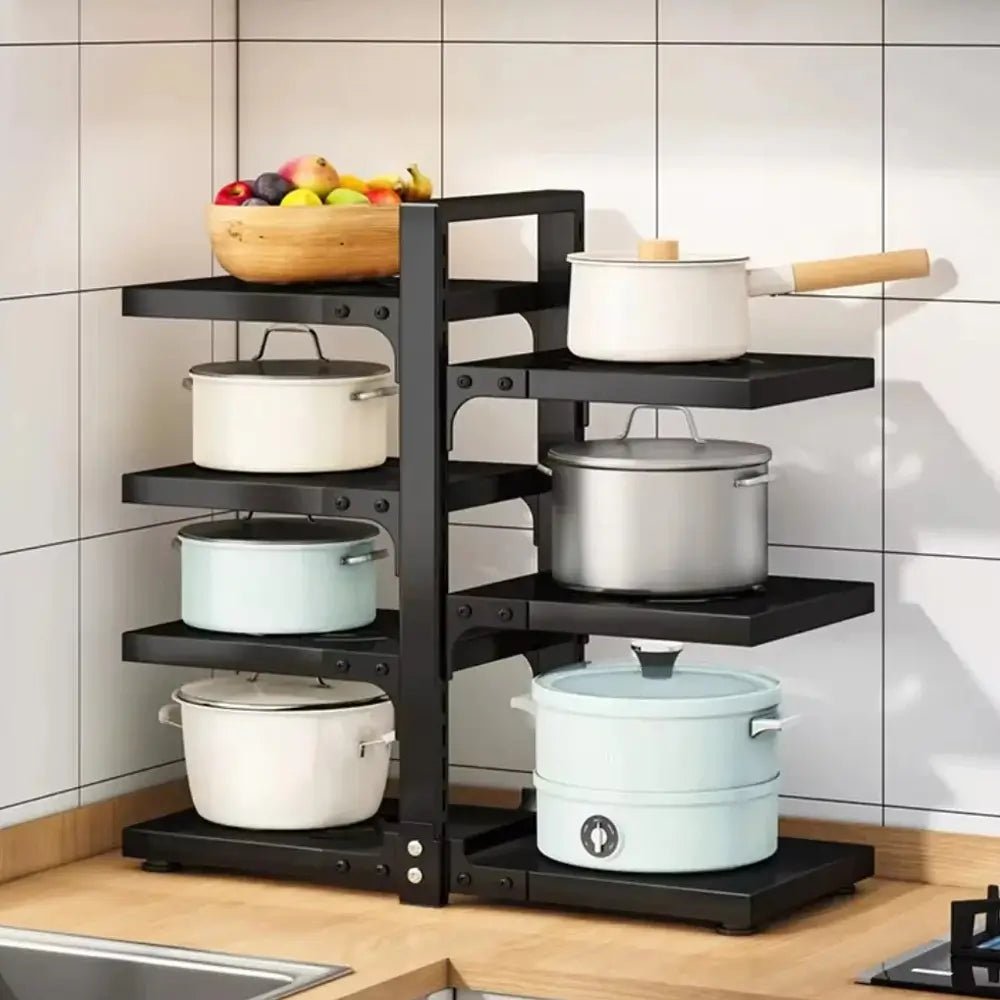 Black multi-tiered kitchen shelf with pots and pans on a tiled wall background