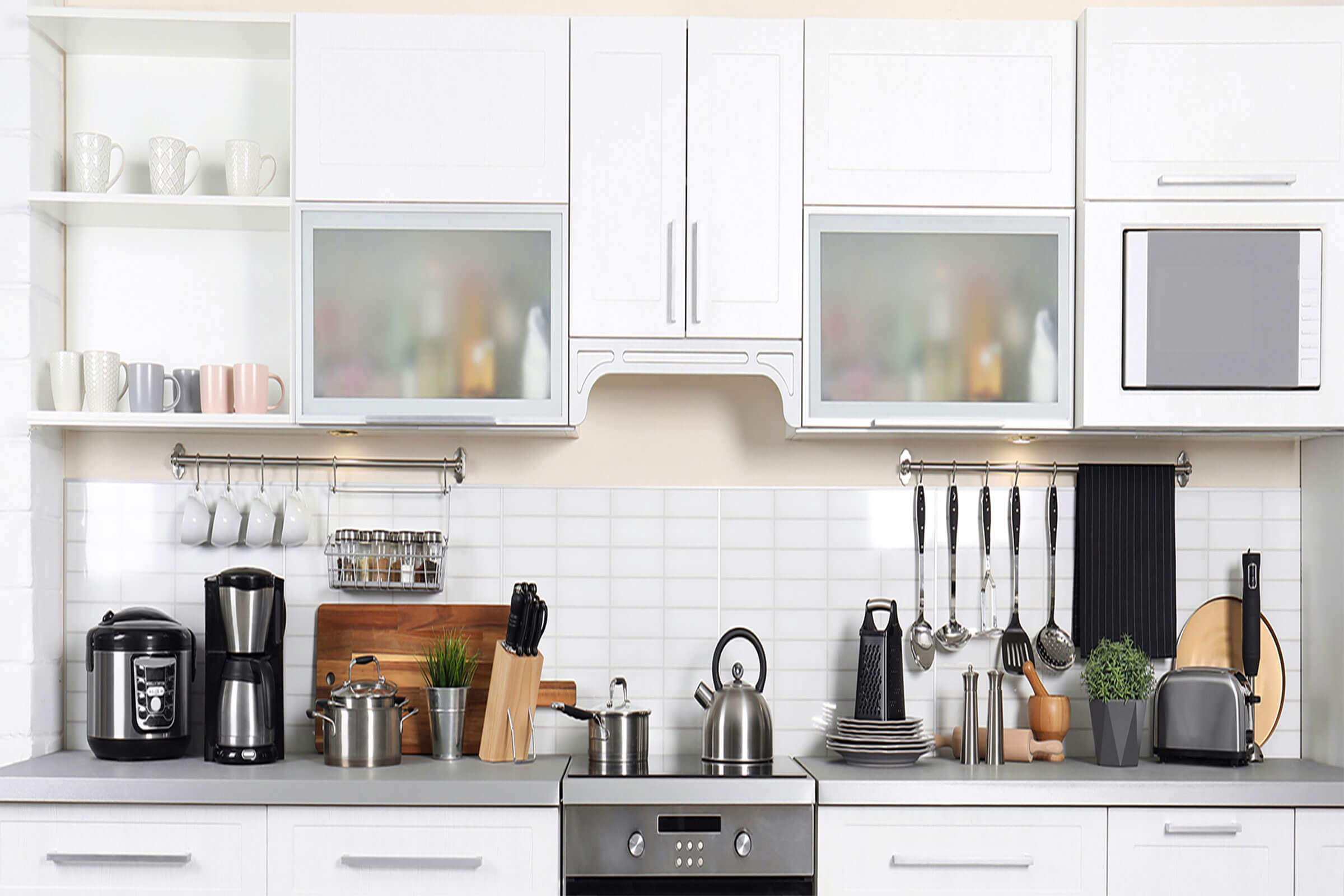 A modern kitchen with organizing kitchen counter ideas, featuring neatly arranged appliances, wall-mounted racks, and smart storage for a clean, functional space.