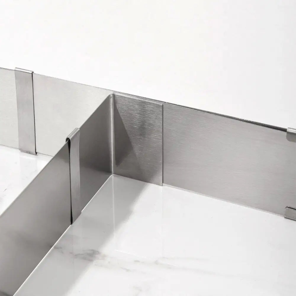 Close-up of an expandable cake ring with adjustable stainless steel panels for baking cakes and layered desserts.