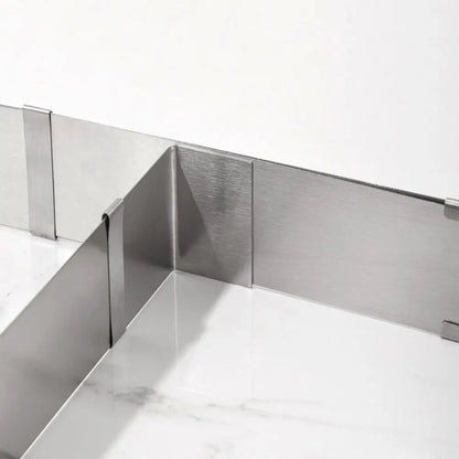 Close-up of an expandable cake ring with adjustable stainless steel panels for baking cakes and layered desserts.