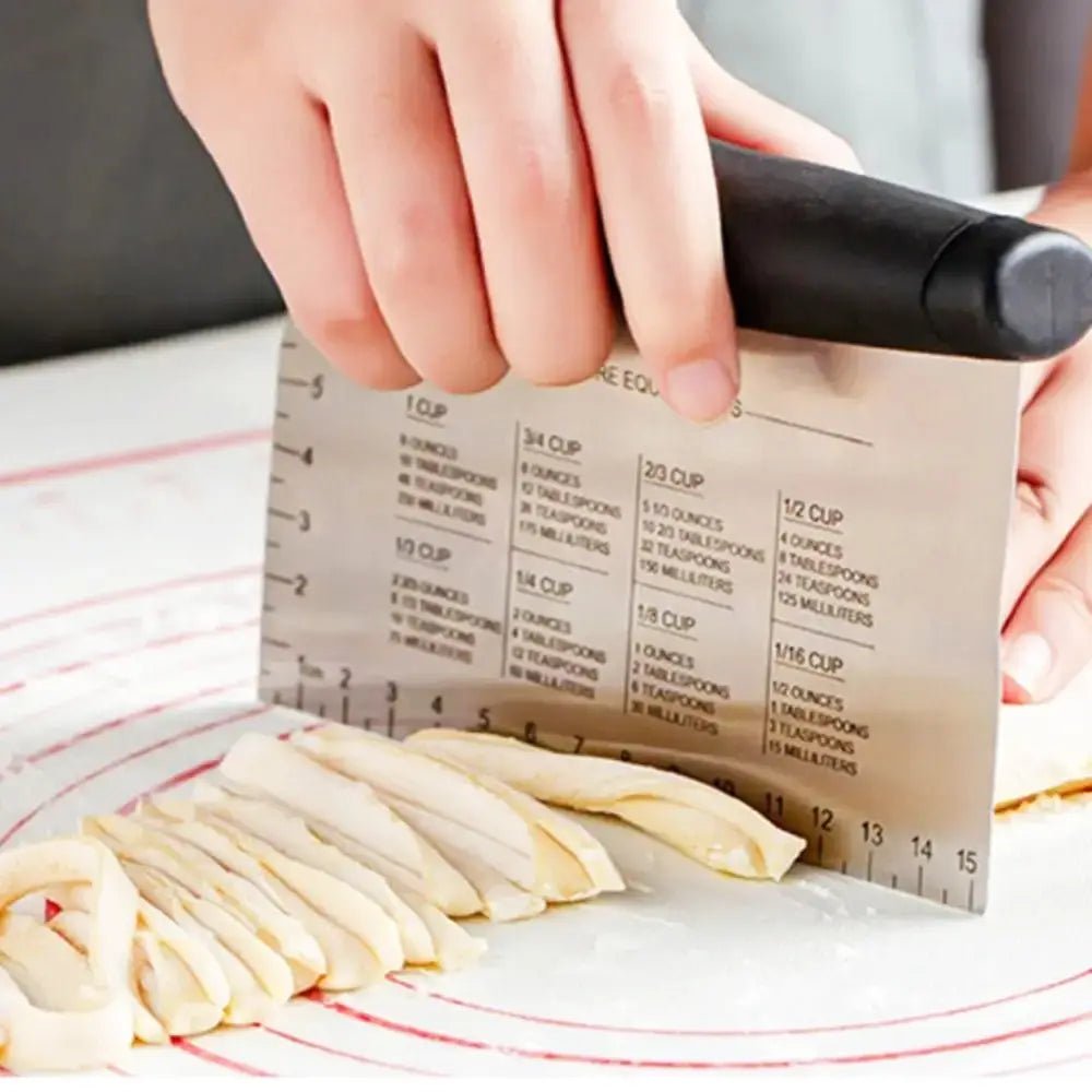 Hand using a measuring tool to cut noodles on a red-lined surface.