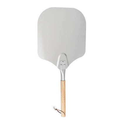 Stainless steel pizza peel with a detachable oak handle, perfect for wood-fired pizza ovens and effortless pizza-making.