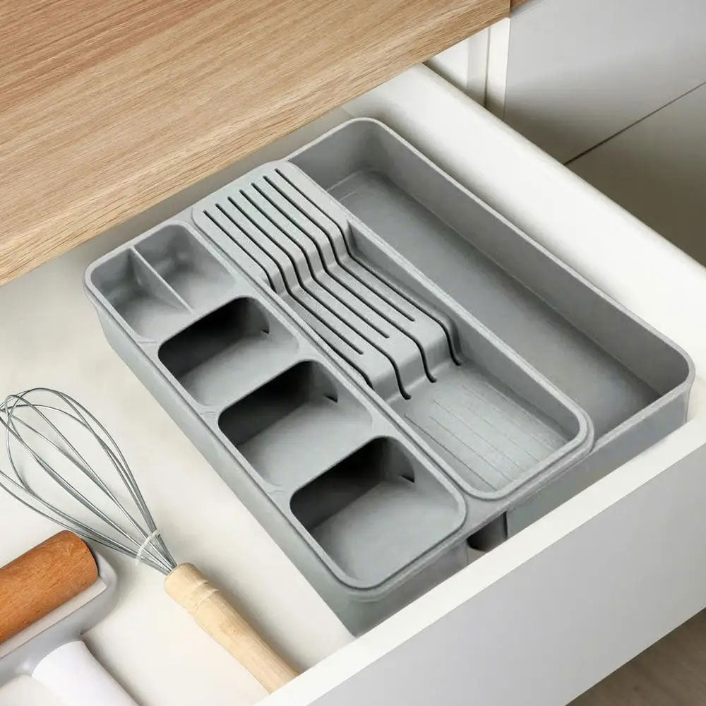 Grey in-drawer knife storage with compartments for organized cutlery placement.