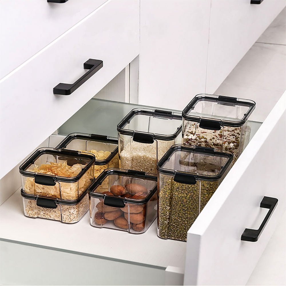 Organized set of plastic sugar and flour canisters in a kitchen drawer, maximizing storage.