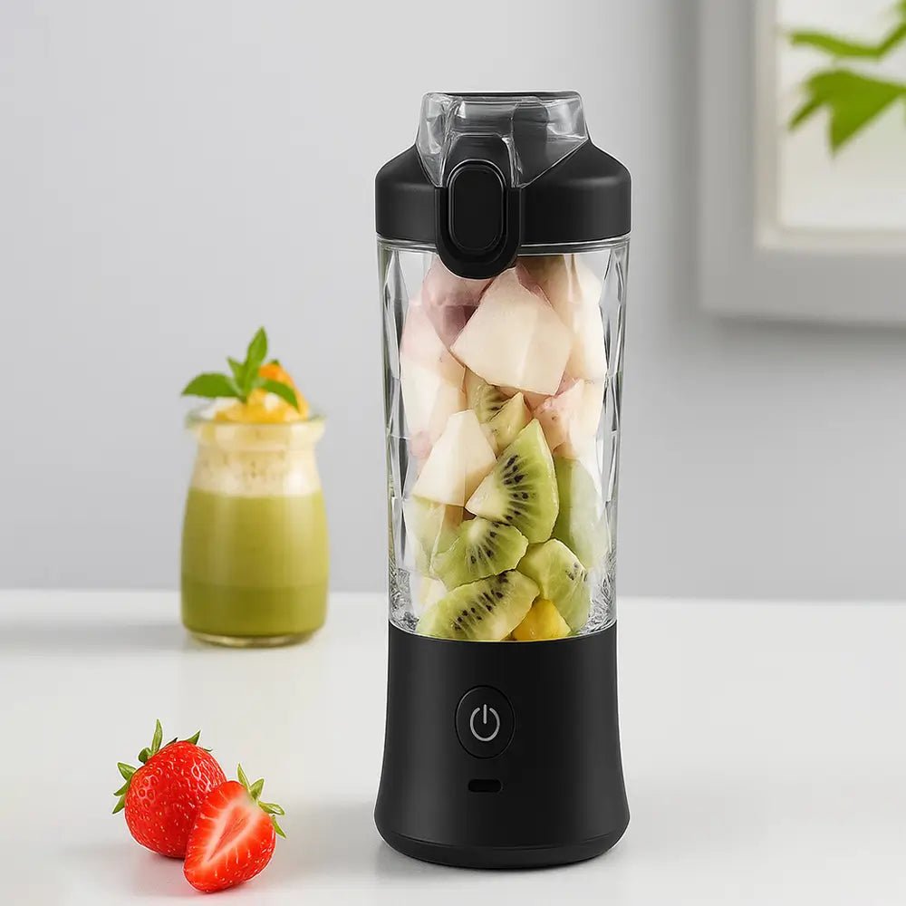 portable blender for smoothie with black lid filled with kiwi and fruit cubes on table beside strawberries and green drink.