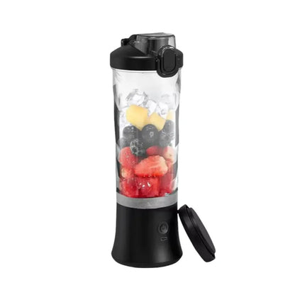 portable blender in black filled with strawberries, blueberries, pineapple, and ice, shown with detachable lid on white background.