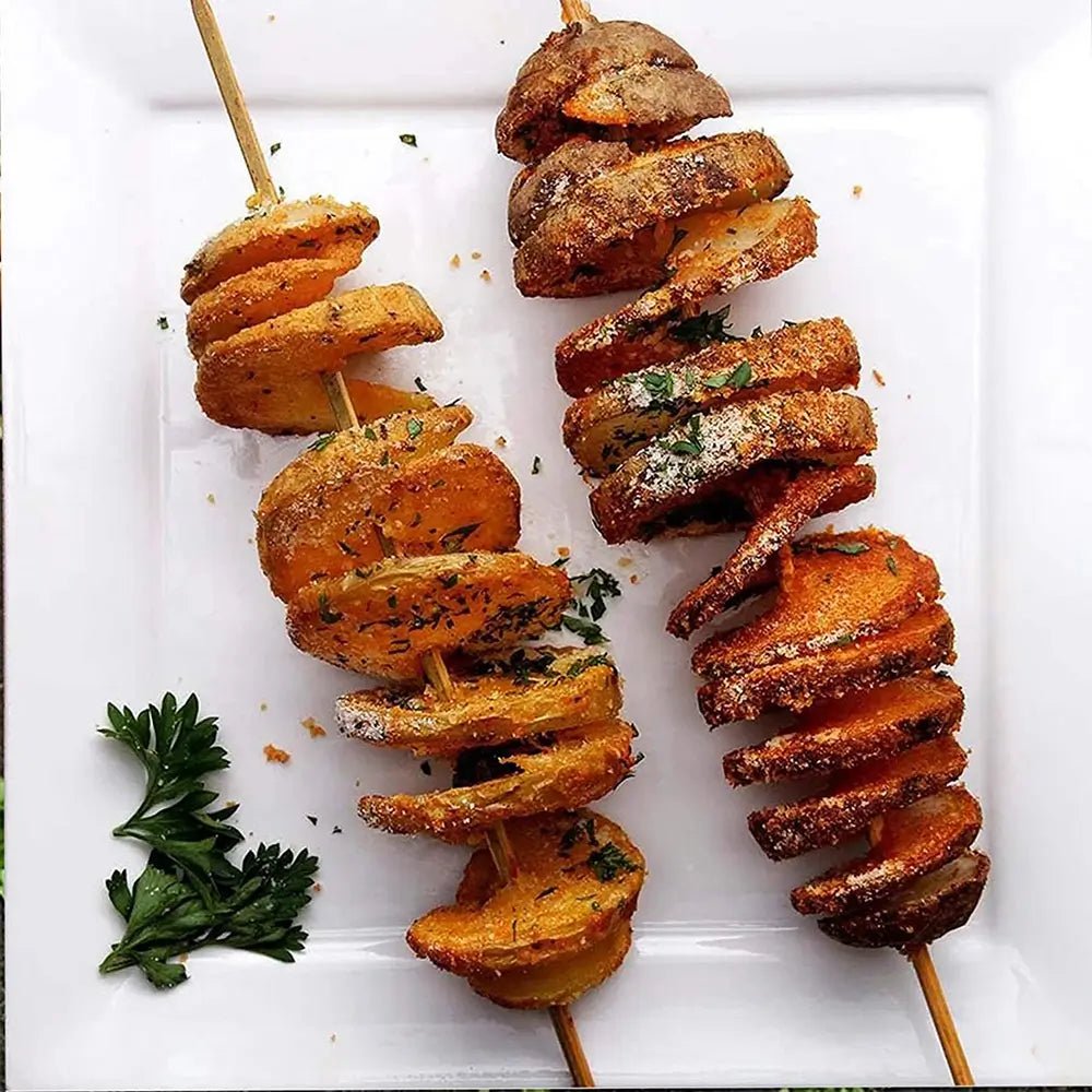 Two skewers of crispy spiral-cut potatoes seasoned with herbs and spices, served on a white plate with a garnish of fresh parsley.