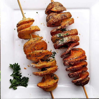 Two skewers of crispy spiral-cut potatoes seasoned with herbs and spices, served on a white plate with a garnish of fresh parsley.