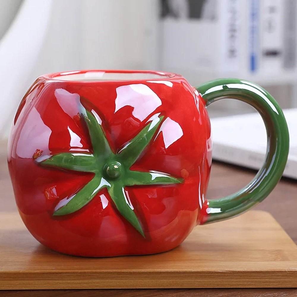 A red coffee mug, tomato shape, with a detailed design and ergonomic handle, made of premium ceramic.