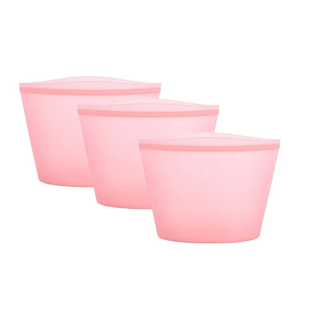 Three pink, tapered reusable silicone bags storage containers are displayed in a row against a plain white background.
