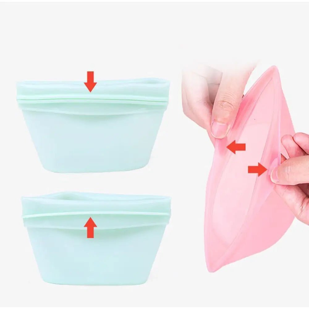 Two light green reusable silicone food bags with red arrows indicating the opening/closing mechanism, and a pink bag being held open by hands.