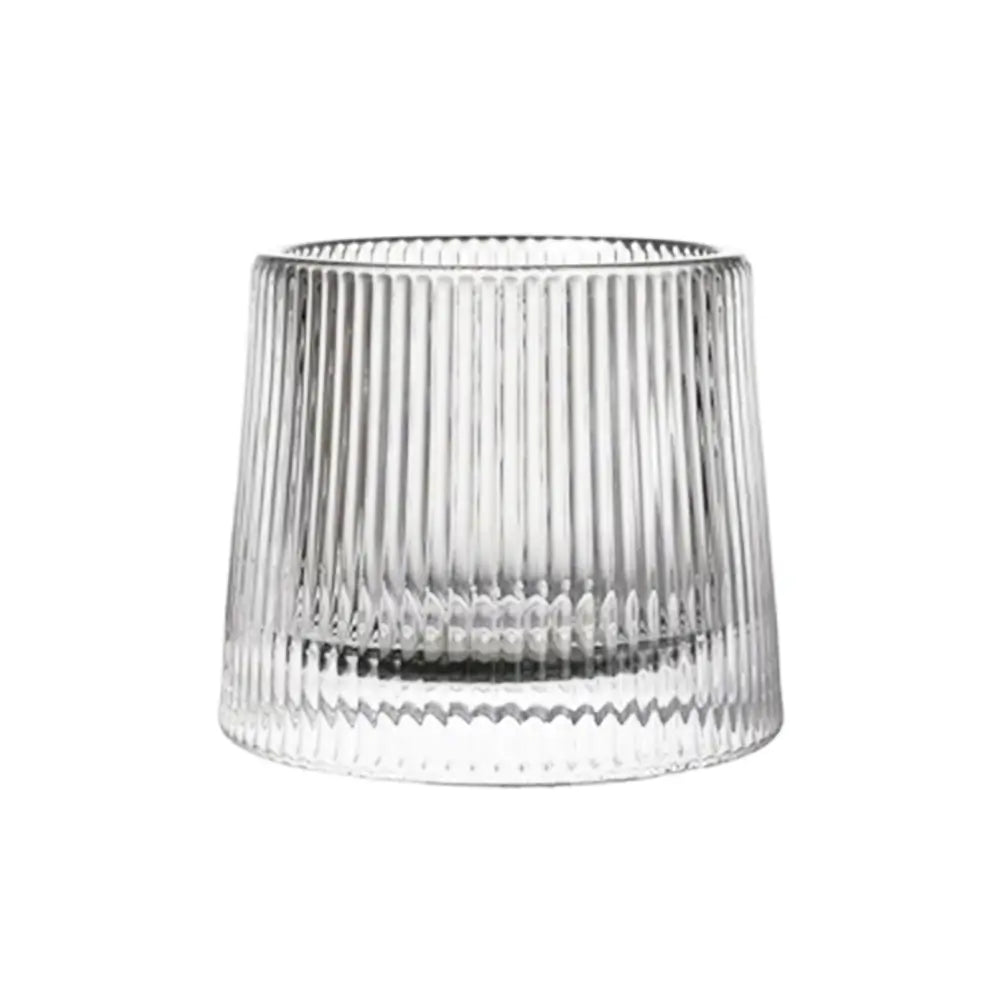 Clear ribbed-glasses tumbler with vertical ridges, thick weighted base, empty and photographed on a white background.