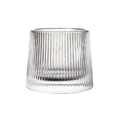 Clear ribbed-glasses tumbler with vertical ridges, thick weighted base, empty and photographed on a white background.