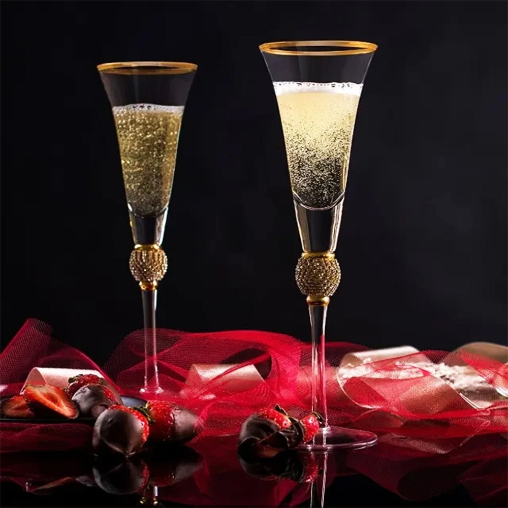 Elegant Riedel flute glasses with a gilded rim and sparkling rhinestones at the stem.