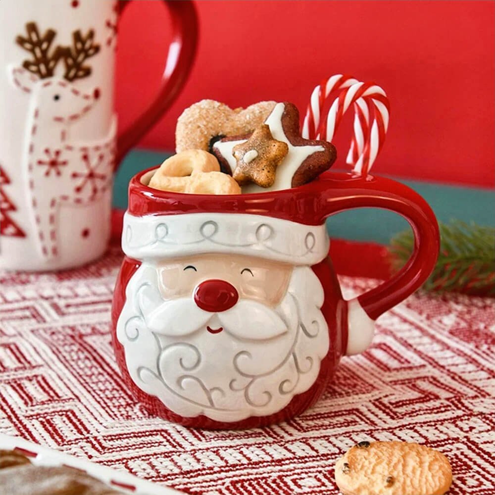 Festive Santa Claus face mug filled with cookies and candy canes, perfect for holiday treats and hot drinks.