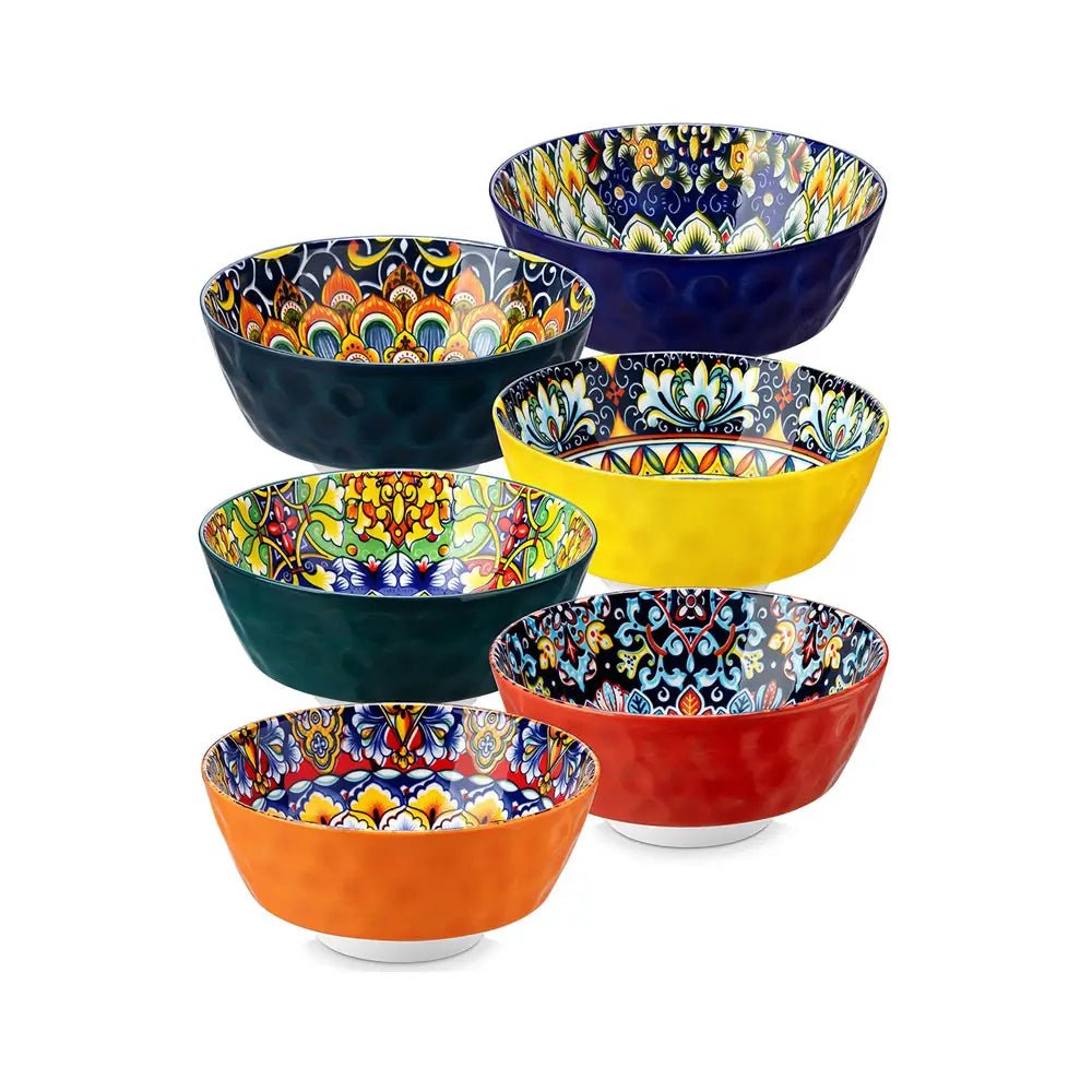 Six colorful ceramic serving bowls with solid exteriors and patterned interiors in blue, red, yellow, green, and orange designs.
