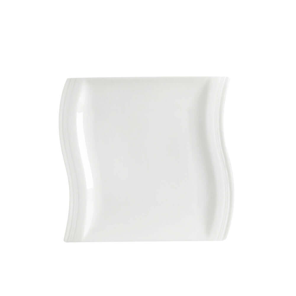 A modern, wavy-edged white ceramic serving plate with a sleek, minimalist design. The plate&