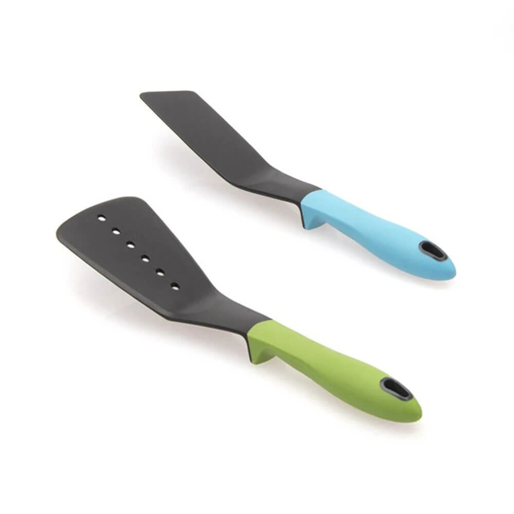 Two tools from a set kitchen utensils: a slotted turner with a green handle and a solid spatula with a blue handle, on a white background.