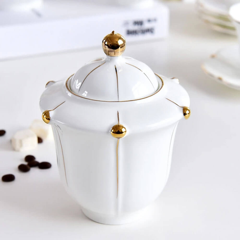 Elegant sugar jar with gold accents from a luxurious set of cups for tea, adding sophistication and charm to any tea time experience.