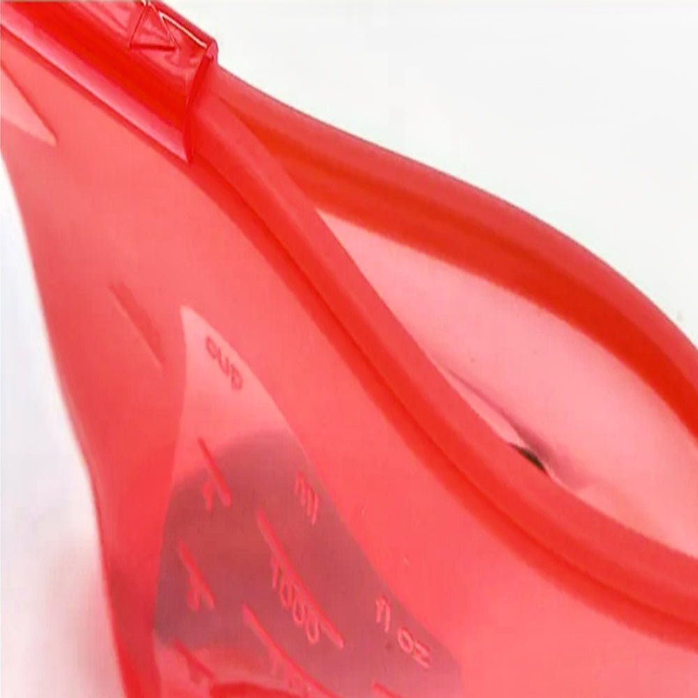 Opened red reusable silicone bags on a kitchen counter, highlighting their flexible, durable design for storing and preserving various foods.