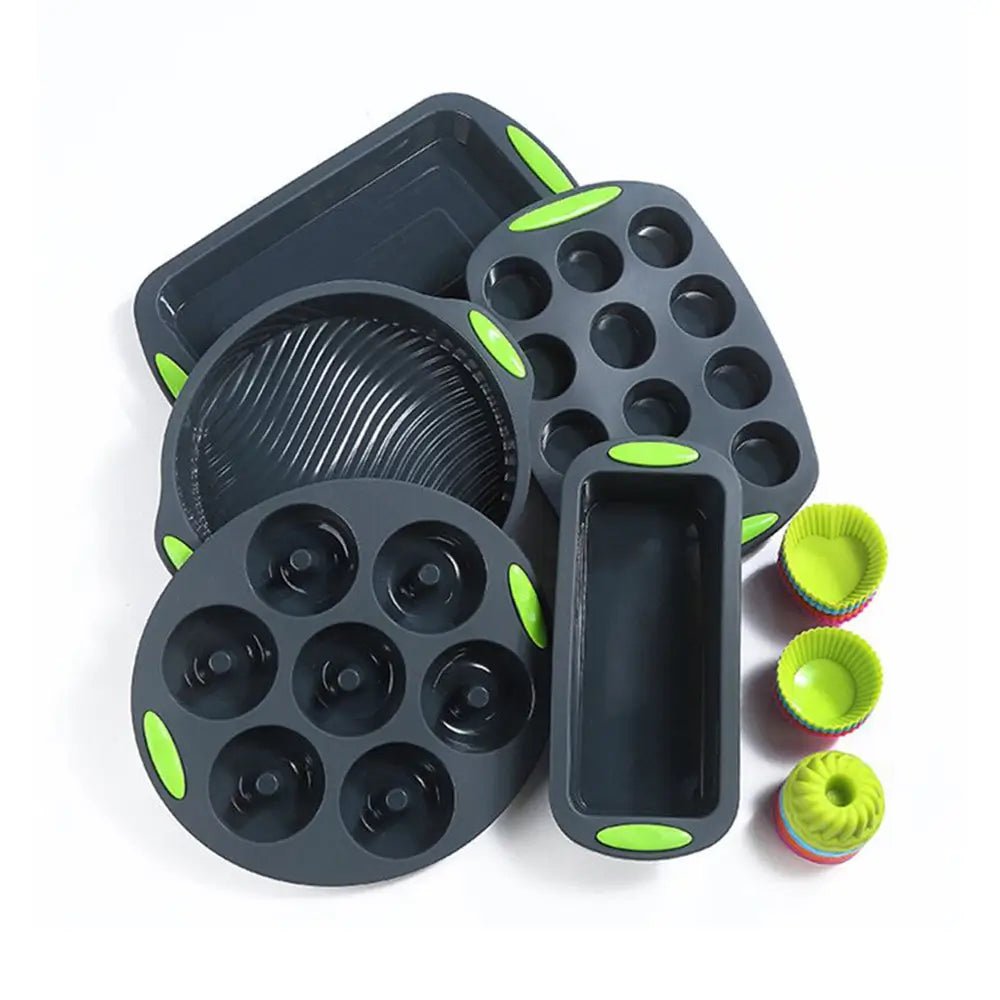 Silicone bakeware set with round, loaf, donut, and muffin molds in black with green handles and colorful baking cups.