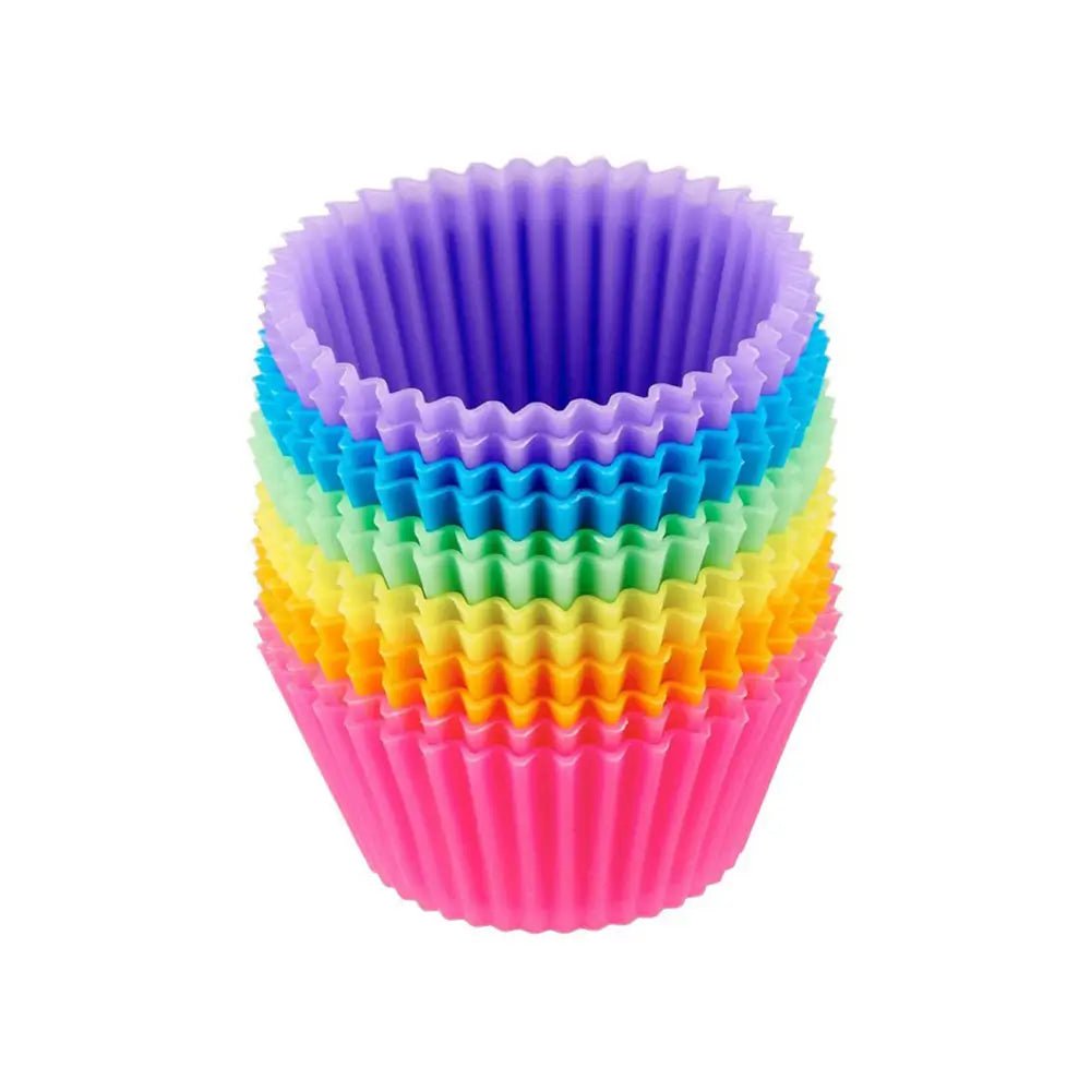 Stacked multicolor silicone baking muffin cups with fluted sides, reusable flexible molds isolated on a white background.