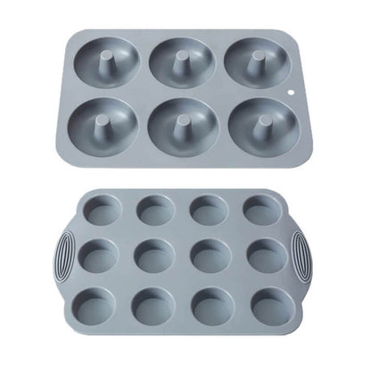 A silicone donut and muffin pan set featuring two gray pans: one designed for baking six perfectly shaped donuts and another for twelve muffins or cupcakes. Both pans have a smooth, non-stick surface for effortless release and are crafted from durable, food-grade silicone.