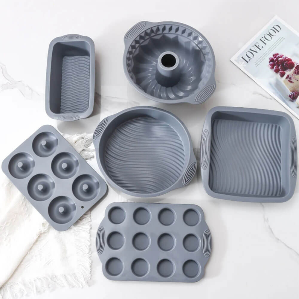 A versatile silicone pan set in a stylish gray finish, featuring six unique pieces designed for a variety of baking needs. The set includes a bundt pan for decorative cakes, a loaf pan for bread and pound cakes, a round pan, a square pan, a donut pan for six donuts, and a mini muffin pan for twelve treats. Each pan is crafted from durable, non-stick silicone for easy release and effortless cleaning, offering perfect results for any baking project.