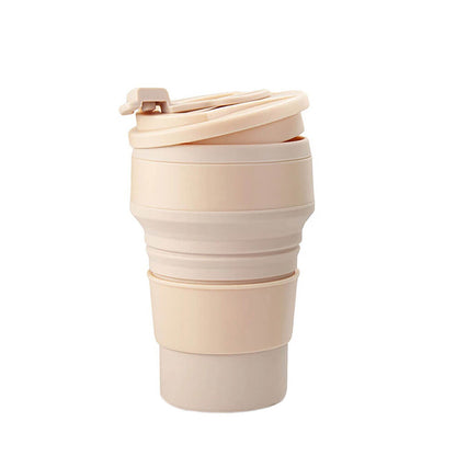 Beige silicone tumbler with a collapsible design, featuring a secure lid and a sleek, portable structure. Perfect for carrying beverages while saving storage space.