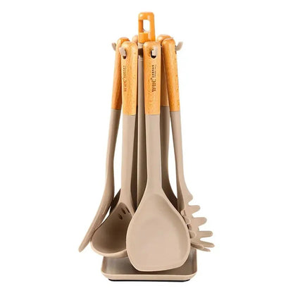 Silicone utensils set with wooden handles on a rotating stand against a white background.