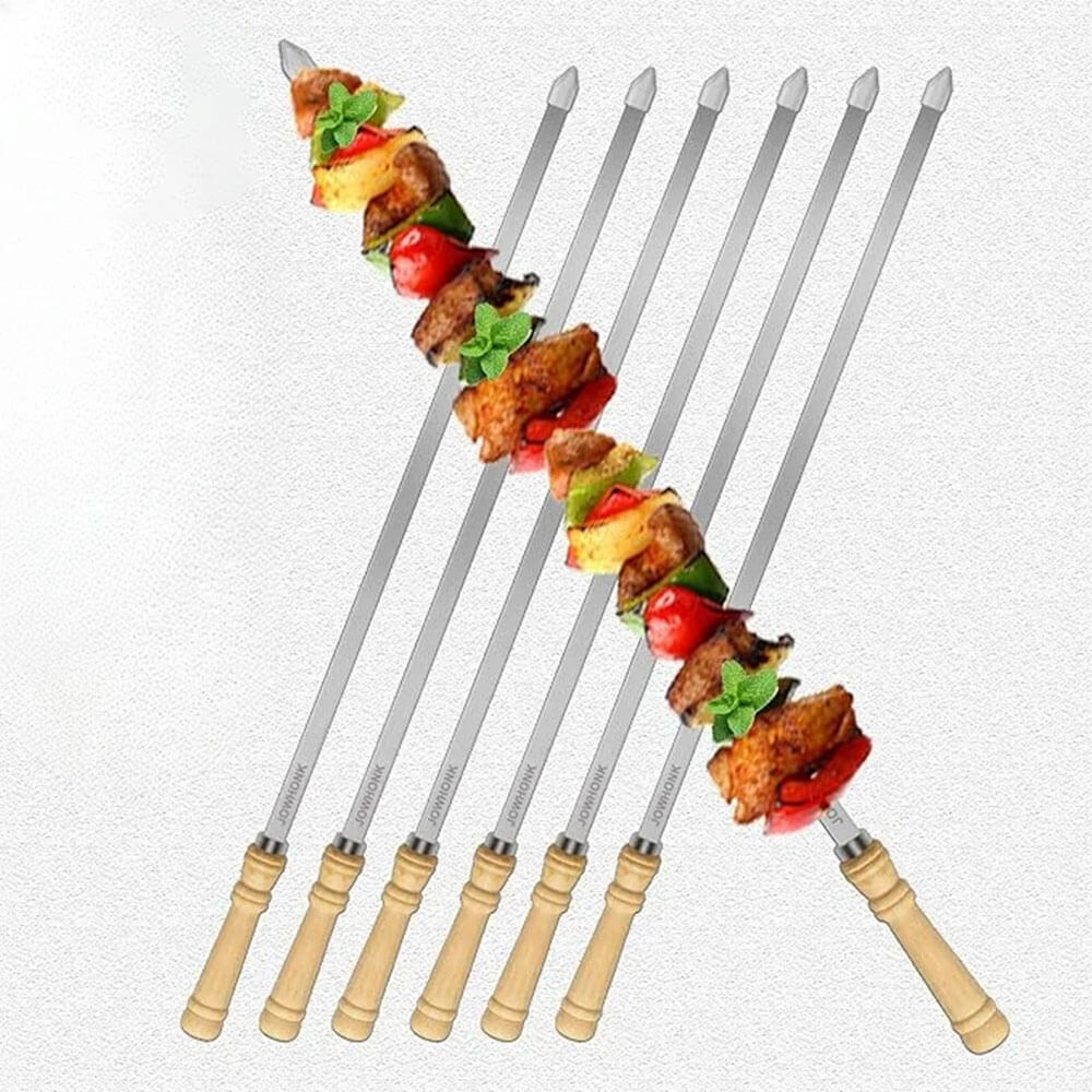 Skewers for grilling with wooden handles, two loaded with grilled meat and veggies, arranged on white background.