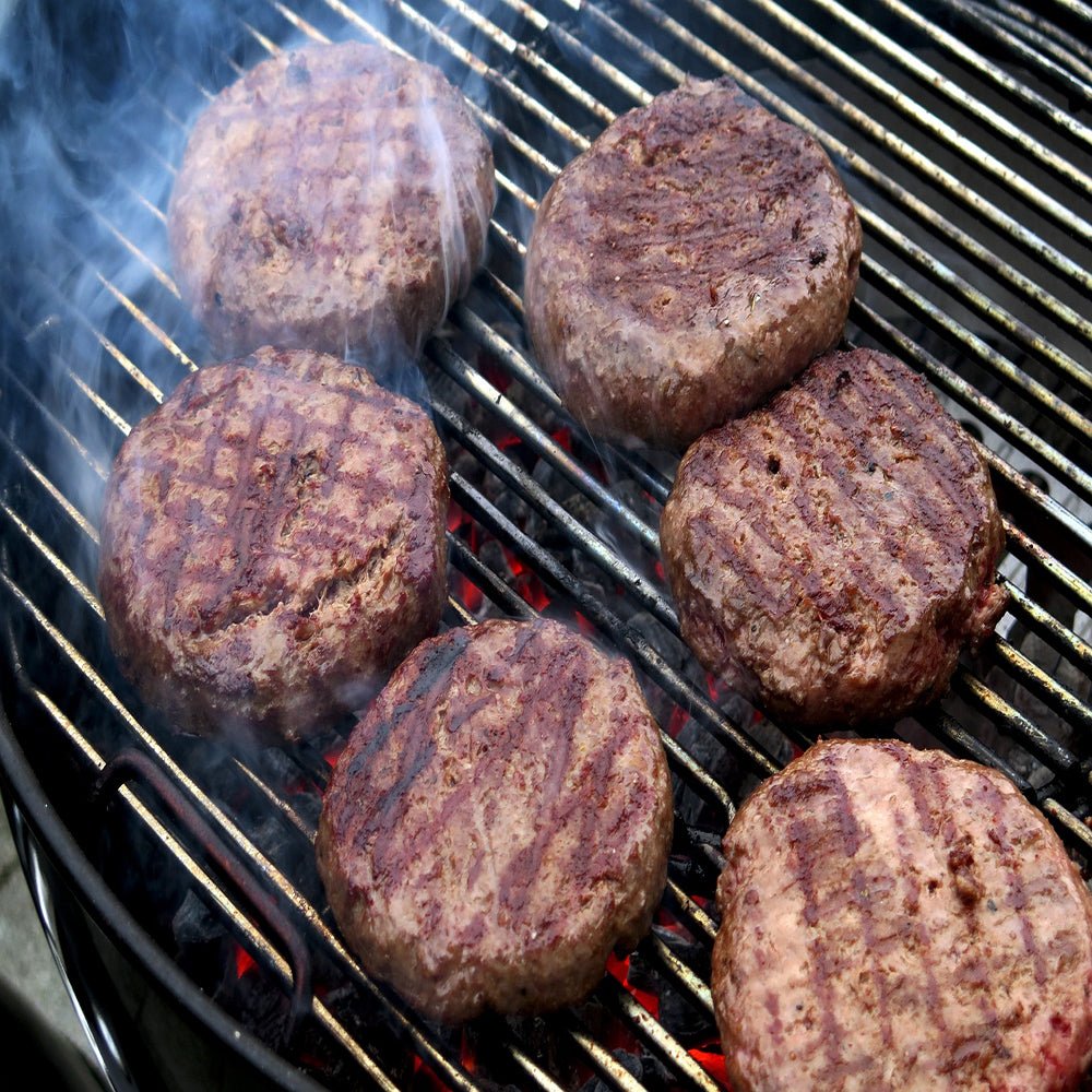 Burgers made with a smash burger press, grilling to perfection with crispy edges and juicy, tender centers.